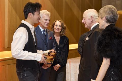 LSO Gala Concert, violinist Simon Zhu holding 'Il Cannone_, The King, Dame Kathryn McDowell (far right)