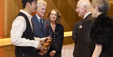 LSO Gala Concert, violinist Simon Zhu holding 'Il Cannone_, The King, Dame Kathryn McDowell (far right)